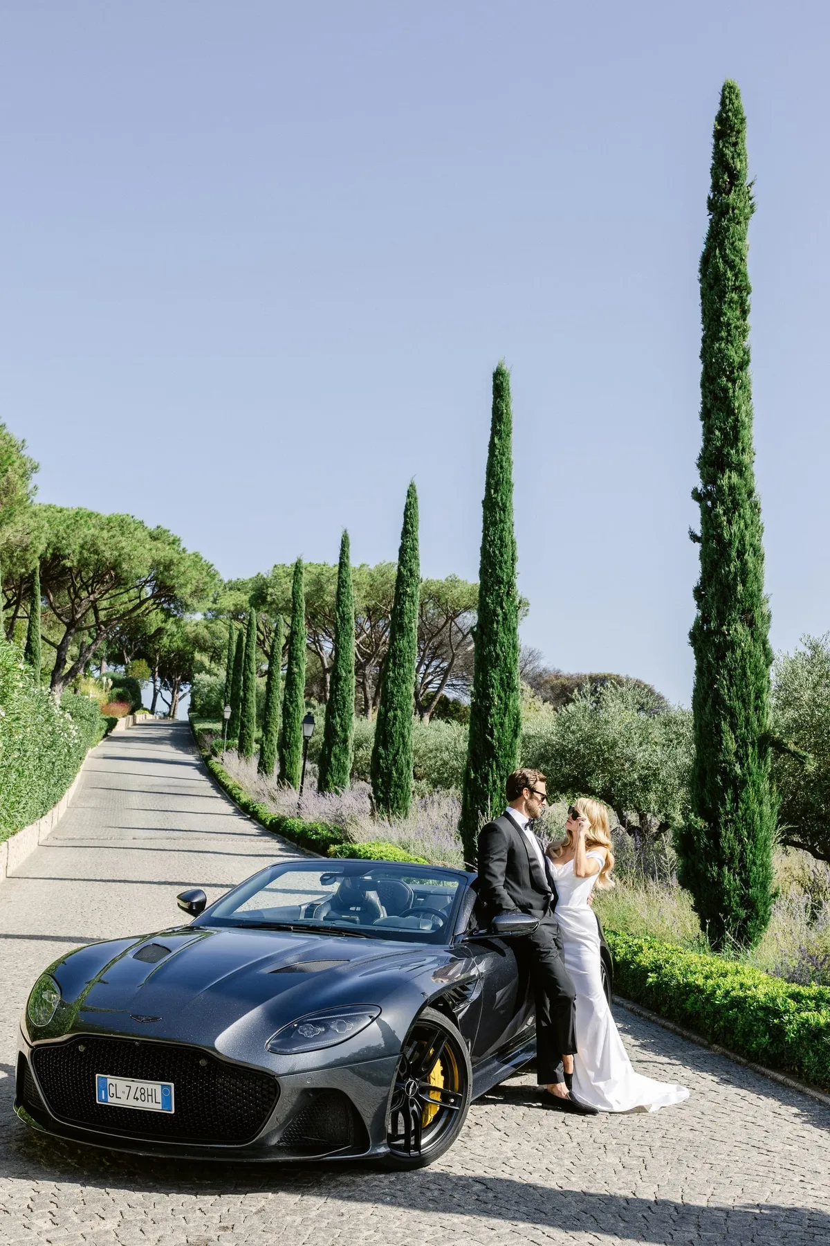 Bride and groom with an Aston Martin at a Saint-Tropez wedding